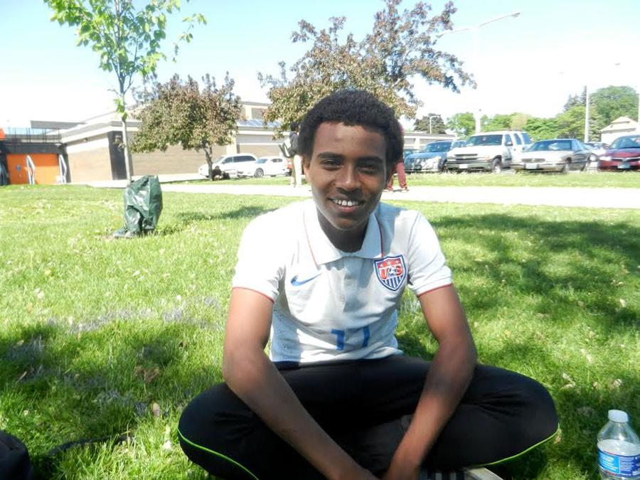 South senior Umar Hassan sits peacefully on the South lawn. He won the Gates Millennium Scholarship, which will give him a full ride through college and graduate school.